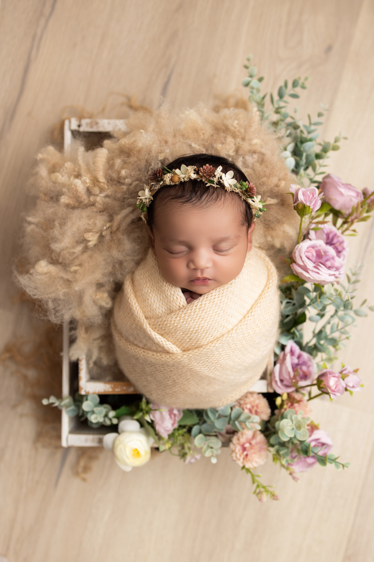 newborn girl in flower basket